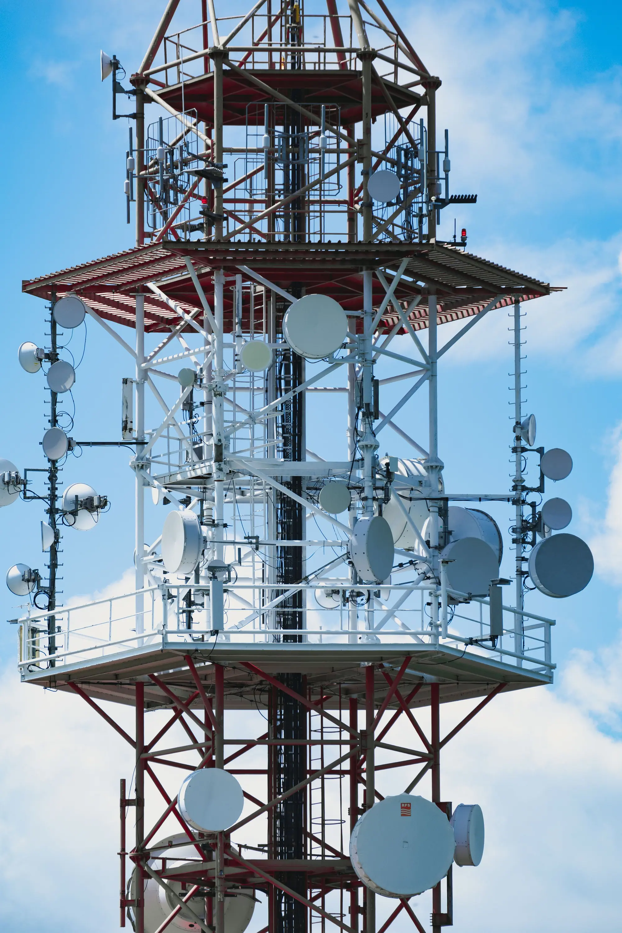 Microwave dishes clustered on a radio tower, a reminder that coverage is a physical plant