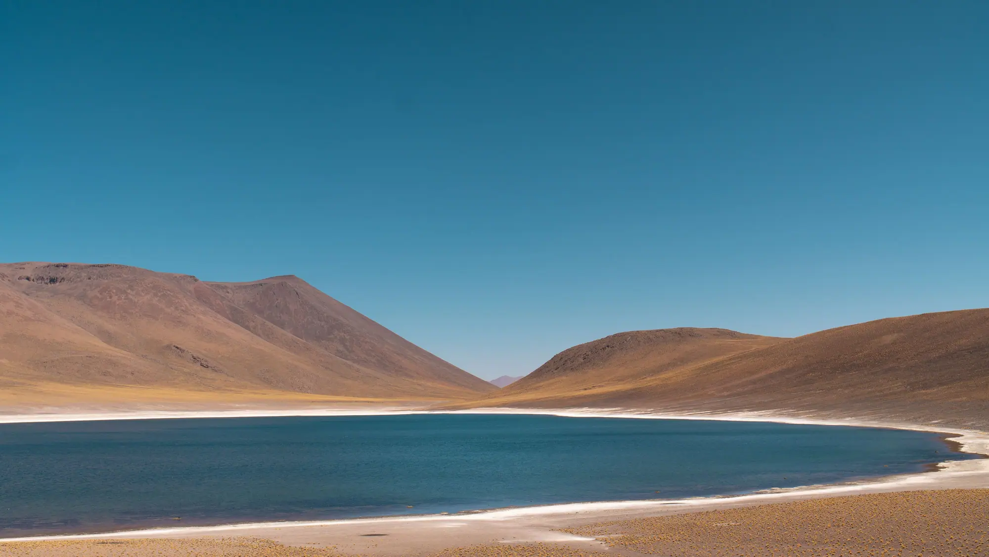 High-altitude lagoon and bare hills on the Atacama plateau