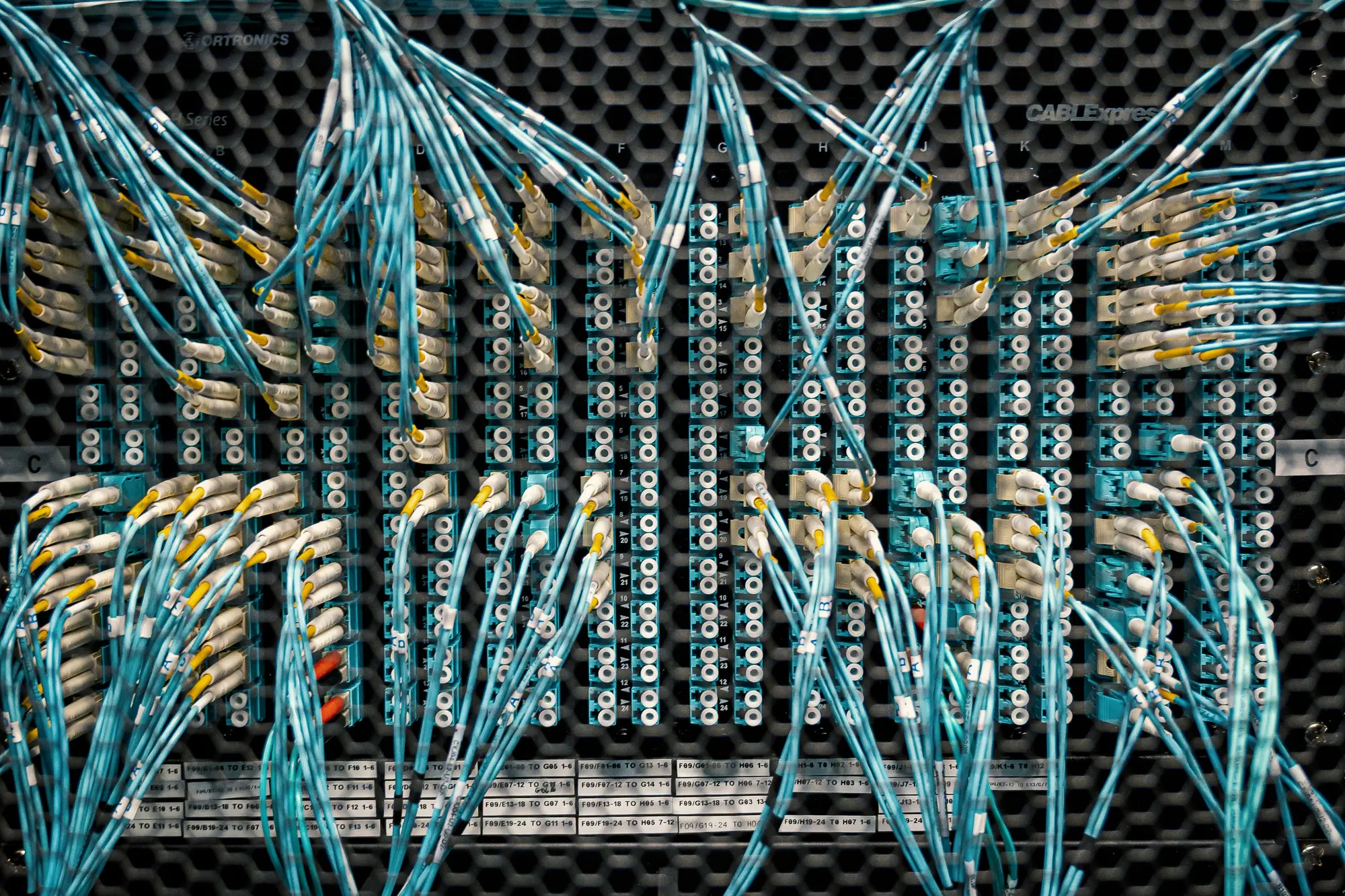 Close view of terrestrial fiber jumpers, the quiet layer under many radio badges