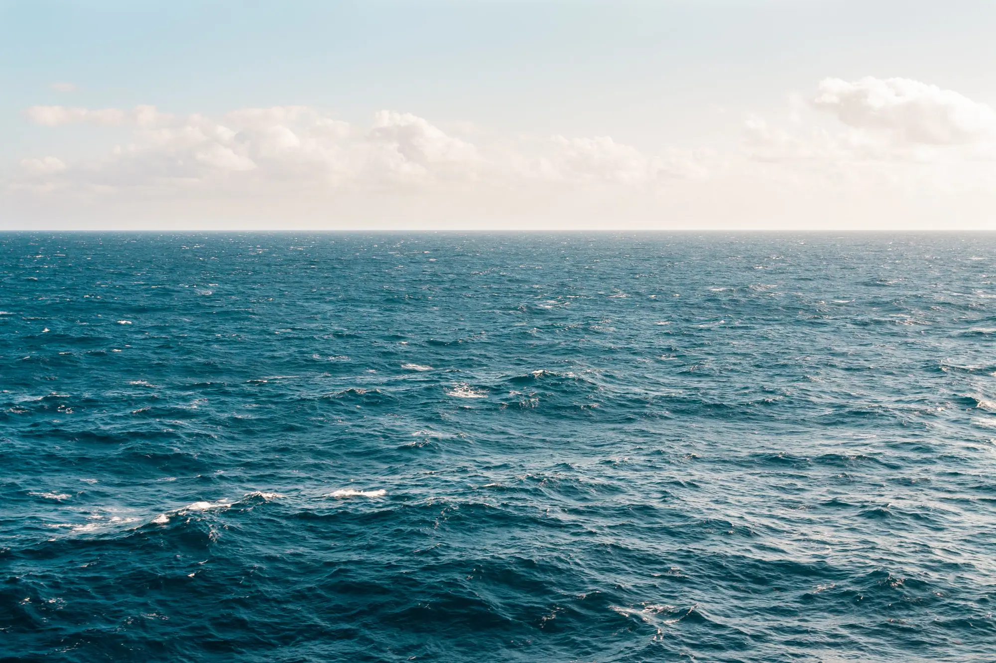 Pacific swell approaching a rocky shoreline, standing in for Chile's cable-landing coast
